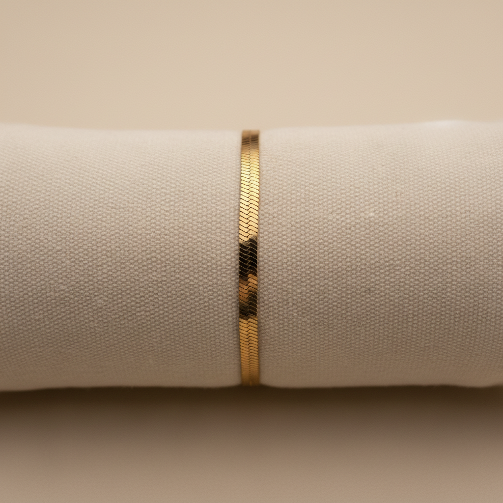 Bracelet chaîne plate dorée sur support lin